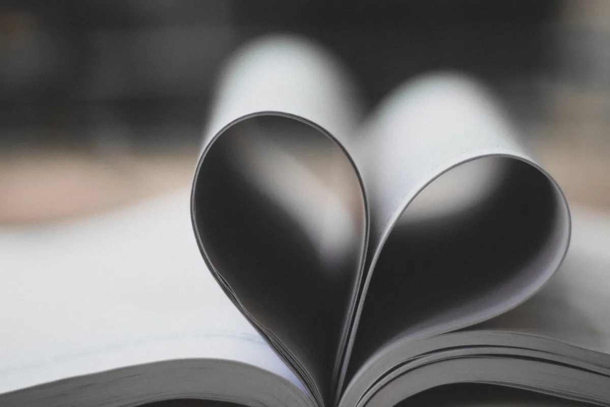 Open book with pages curved into a heart shape
